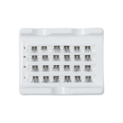 Tray displaying four rows of false eyelash clusters in varying lengths labeled from S to L (short to long), arranged on a white plastic holder.